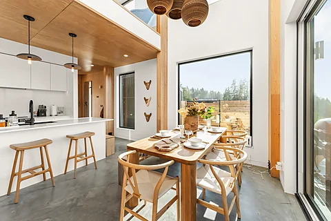 Vaulted A-frame kitchen and dining area with panoramic window views