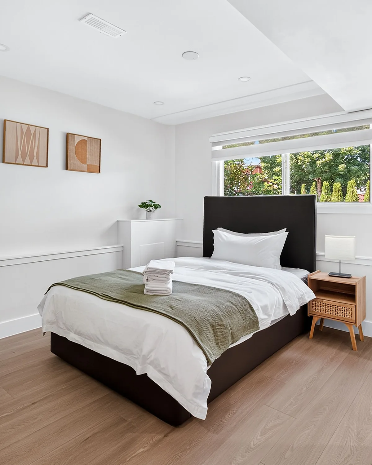 Staged bedroom with folded linens on the bed