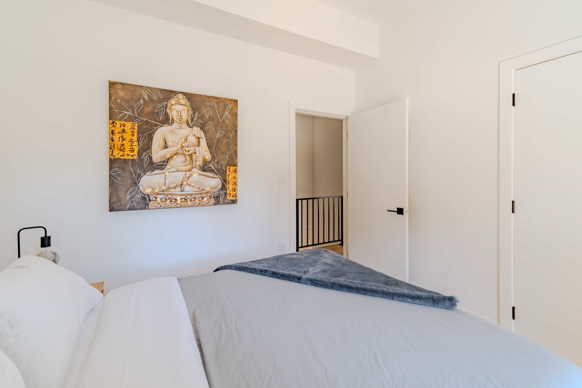 Cozy bedroom with warm artwork in Airbnb property