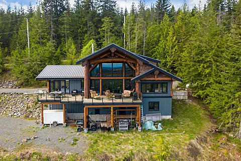 Aerial view of a timber-frame home with a wraparound deck