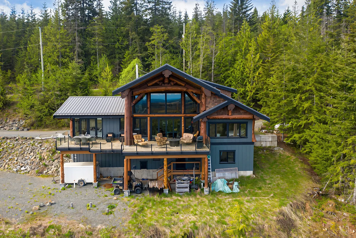 Aerial view of a lodge building surrounded by forest in British Columbia