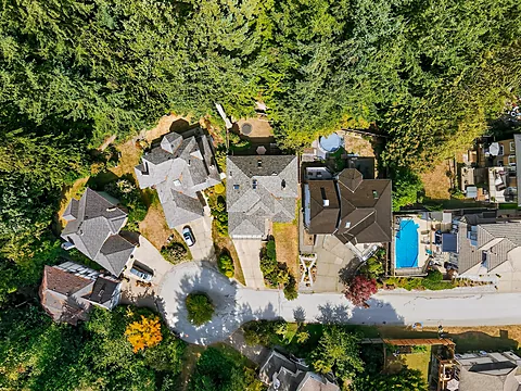 Top-down aerial view of a home with a backyard pool