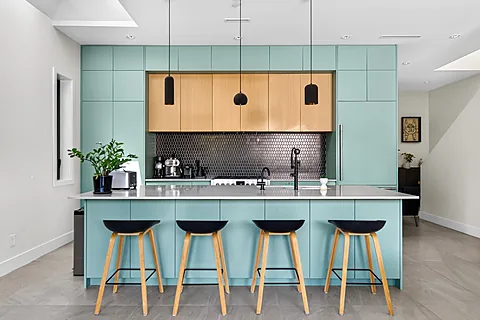 Kitchen with island seating off an open living area