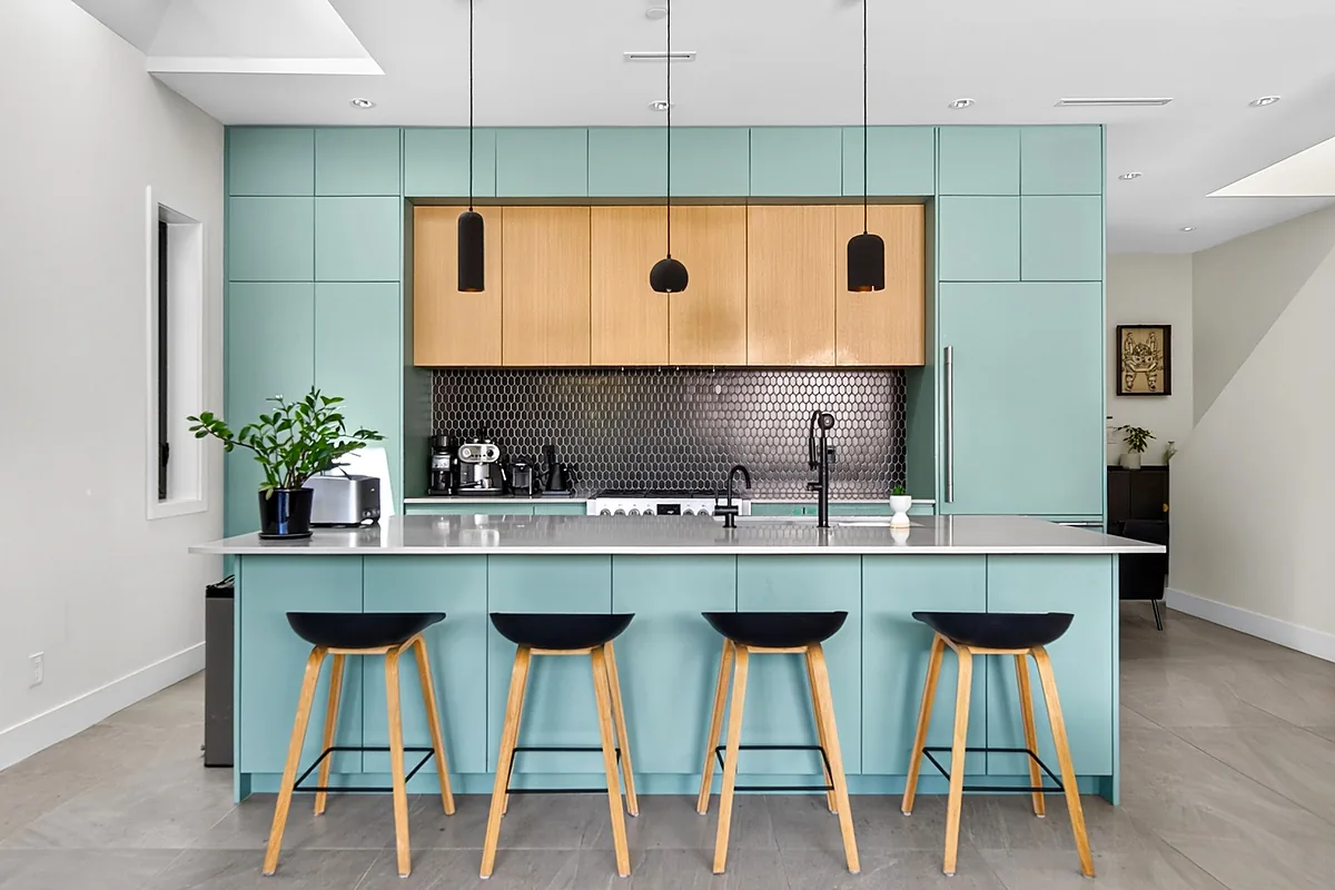 Teal kitchen with island seating in a Vancouver home