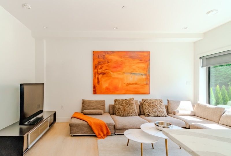 Bright open-plan Vancouver condo living room with warm natural light and hardwood floors — standard MLS real estate photography package