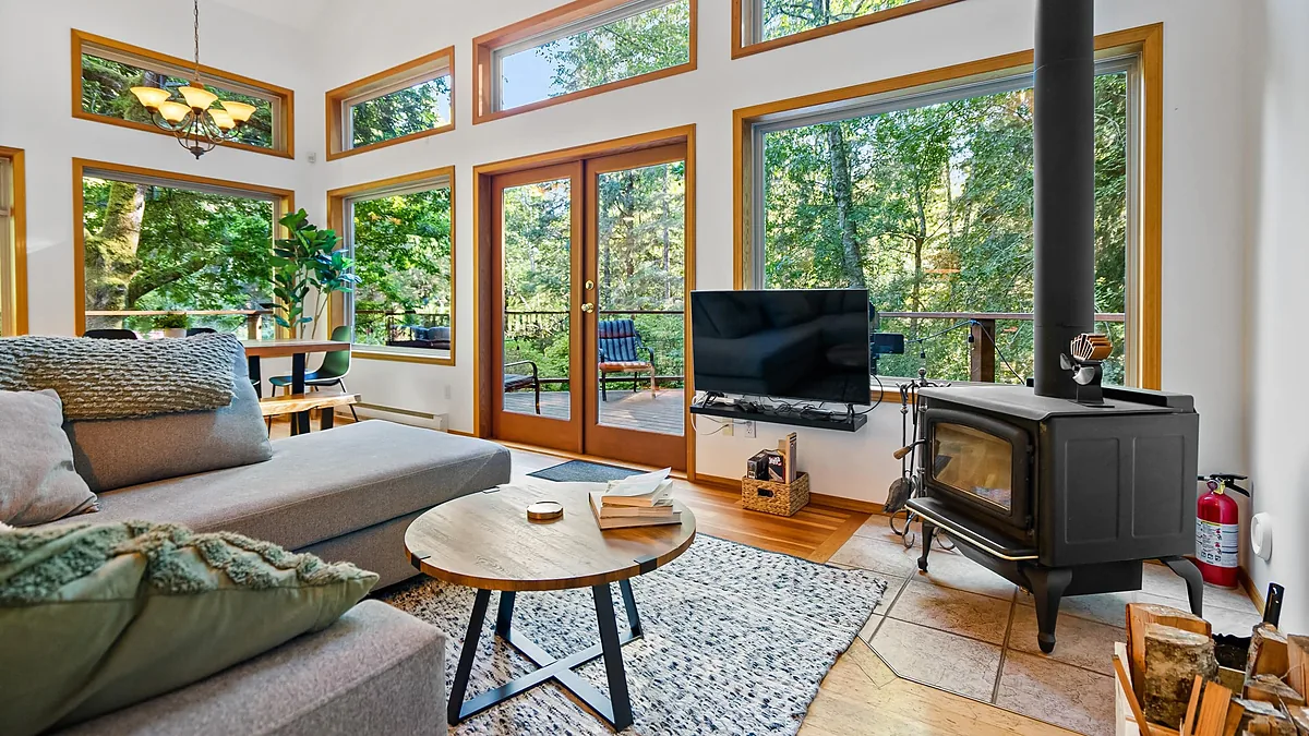 Cabin living room with a wood stove, listing video frame